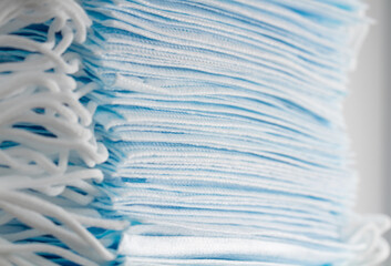 Large stack of medical disposable face masks close-up.