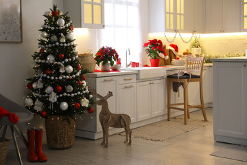 Beautiful kitchen interior with Christmas tree and festive decor