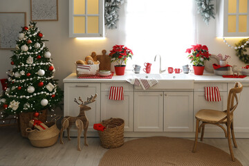 Beautiful kitchen interior with Christmas tree and festive decor