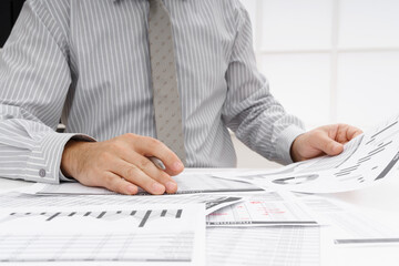 business concept - businessman's working table close view, checks financial reports, writes and counts