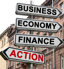 The road indicator on the arrows of which is written - business, economics, finance and ACTION