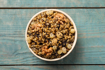 Traditional Christmas slavic dish kutia on light blue wooden table, top view