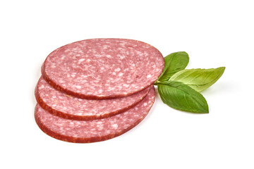 Sliced salami sausage with basil leaves, close-up, isolated on white background