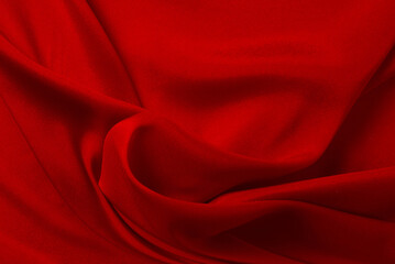 Red silk or satin luxury fabric texture can use as abstract background. Top view.