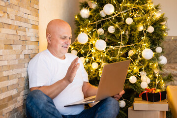 Online communication in quarantine and staying in touch with relatives. Grandfather at home on...