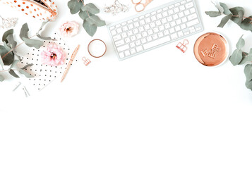 Feminine desk scene - flatlay with keyboard and eucalyptus