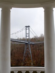 pedestrian bridge support in frame of white columns of belvedere