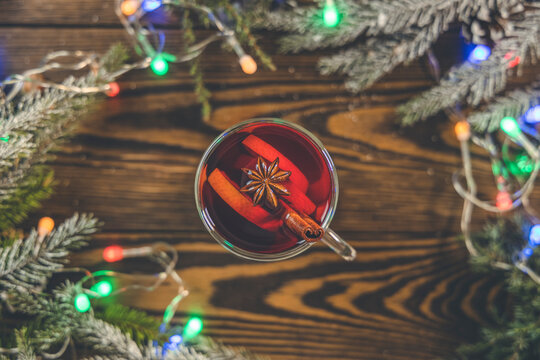Christmas hot mulled wine in a glass with spices and citrus fruit. Mulled wine with cinnamon, anise and orange. Top view and copy space