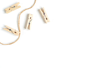 wooden clothespins and rope on a white background
