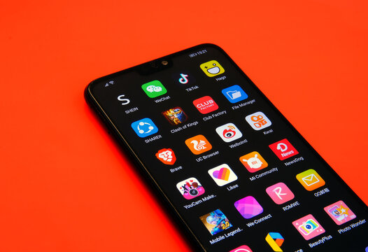 Stone / UK - June 30 2020:  TikTok And Other Chinese Apps Banned In India Due To Security Concerns On The Smartphone Screen Placed On Red Surface.