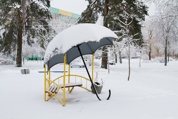 Gazebo trees and Playground in the snow. The Blizzard brought a lot of snow and snow drifts. Winter city.