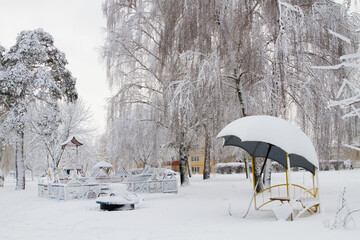 Gazebo trees and Playground in the snow. The Blizzard brought a lot of snow and snow drifts. Winter city.