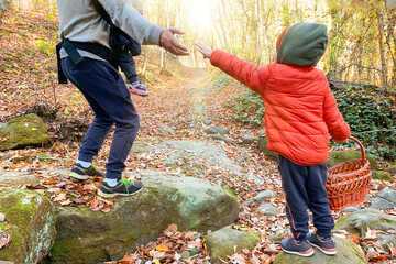dad helps his son jump.