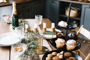 Festive Christmas table in the kitchen with a large Christmas tree and decorations.