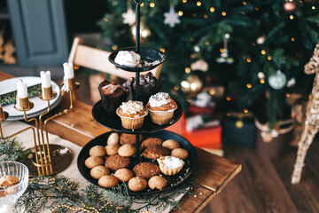 Festive Christmas table in the kitchen with a large Christmas tree and decorations.