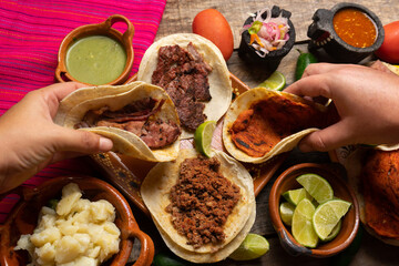 Assortment of mexican tacos on wooden background