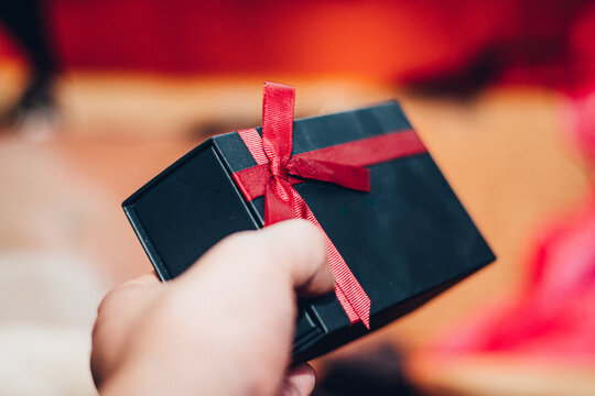 Holding a gift box - image of scene about celebration / holiday season / birthday / christmas / Valentain's day
