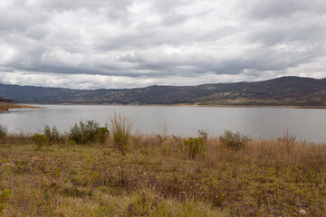 Tomine Reservoir autumn scene landscaper with blue mountains and cloudy sky. Travel and nature concept