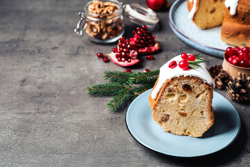 Composition with piece of traditional homemade Christmas cake on grey table, closeup. Space for text