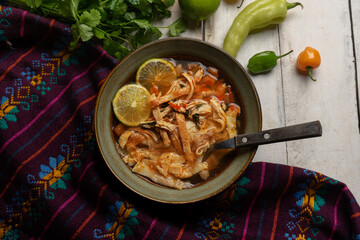 Mexican lime soup with chicken on white background