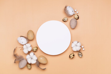 Easter eggs on beige pastel background with space for text. Flat lay image composition, top view.