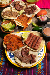 Assortment of mexican tacos on wooden background