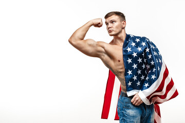 Handsome young man's torso covered with american flag.