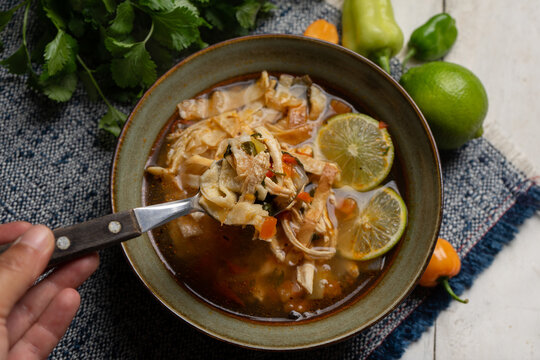 Mexican lime soup with chicken on white background