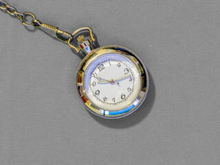 Small steel pocket watch with white dial