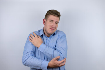 Business young man wearing a casual shirt over white background hugging oneself happy and positive, smiling confident