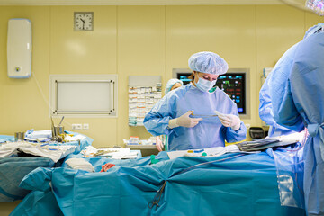 The doctor's assistant helps the surgeon during the operation