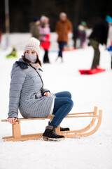 person sitting on a sledge