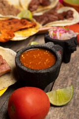 Mexican red sauce at taqueria on wooden background
