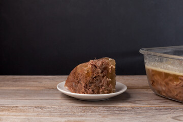 Piece of beef jelly on an old wooden rustic table. Selective focus, dark background, copy space.