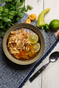 Mexican lime soup with chicken on white background