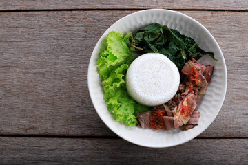 Se'i Sapi or  Beef Sei is Indonesia Traditional Smoked Beef, Served with Boiled Cassava Leaves and Sambal Luat or Sambal Matah. Typically Food from Nusa Tenggara, Indonesia