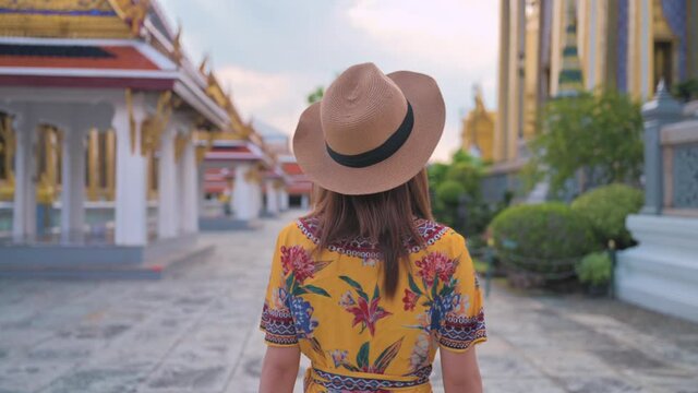 Asian woman visiting Wat Phra Kaew or Emerald buddha temple in Bangkok Thailand