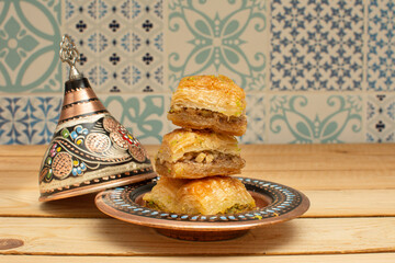 Closeup of traditional Turkish dessert - baklava (this kind of baklava call Civizli baklava). Most popular in Ramadan time (Turkish: Ramazan bayrami). Side view.