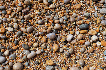 Sea beach pebble stones in sea water.
