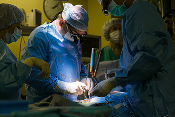 Surgeons in the operating room do operation