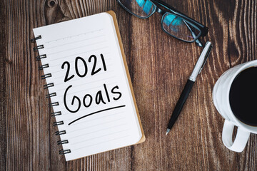 2021 Goals on Notebook over Wooden Work Desk