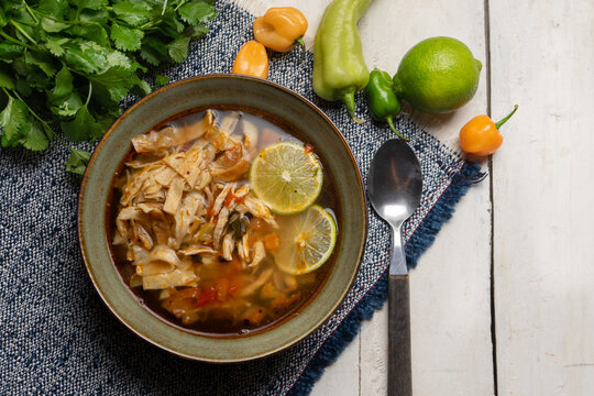 Mexican lime soup with chicken on white background