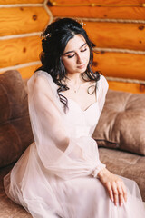 Portrait of brunette bride in powdery dress with stylish hairstyle and wedding manicure