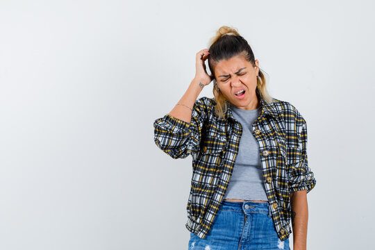  Young Lady Scratching Head In T-shirt, Jacket, Jeans And Looking Fatigued. Front View.