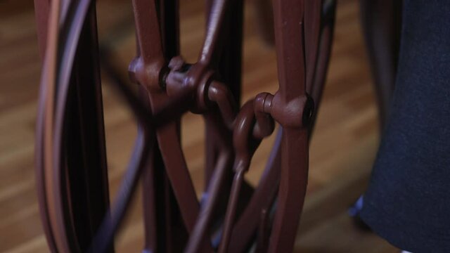 Female feet pressing pedal of sewing machine