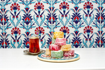 Turkish tea in traditional glass near Turkish delight.