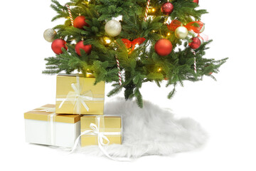 Beautiful decorated Christmas tree with skirt and gift boxes on white background