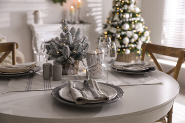 Festive table setting and beautiful Christmas decor indoors. Interior design