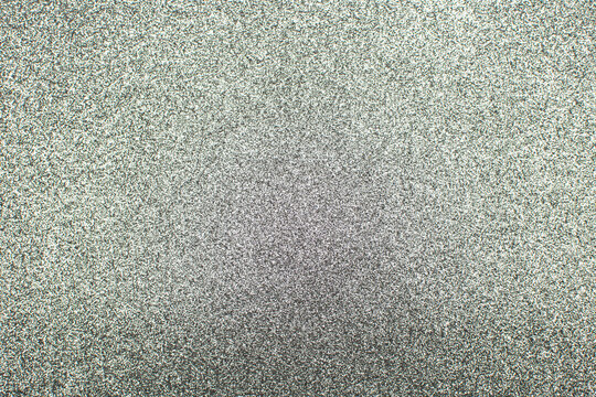 Closeup of silver glitter texture. Photo of grey sparkle dust background.