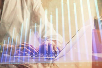 Double exposure of woman hands typing on computer and forex chart hologram drawing. Stock market invest concept.